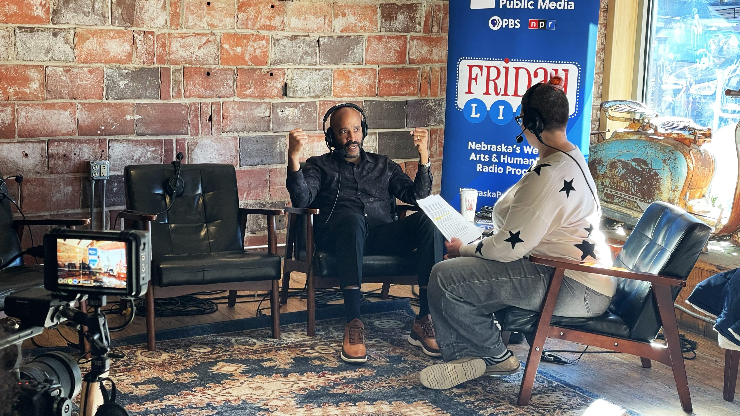 Photo of two people conducting an interview on camera