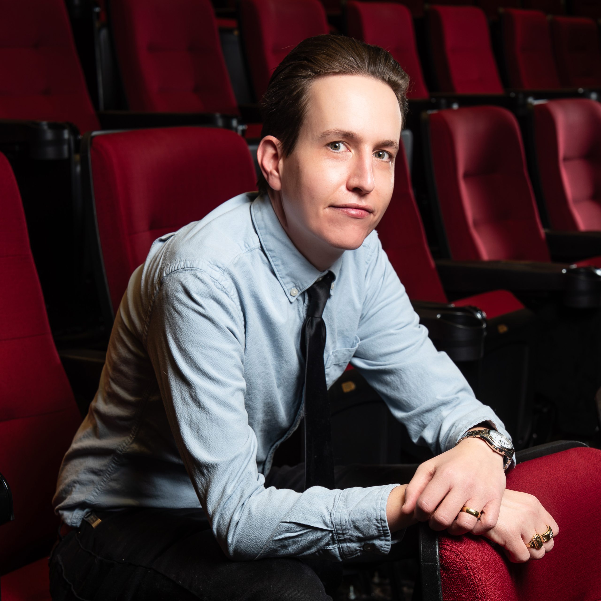 Photo of James Wachtel sitting in a red theater chair