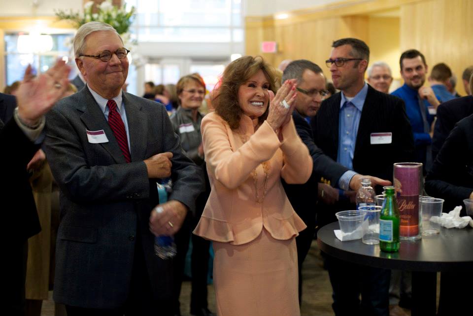 Lucy Buntain Comine winning MRR Award, Group of people clapping for her in background
