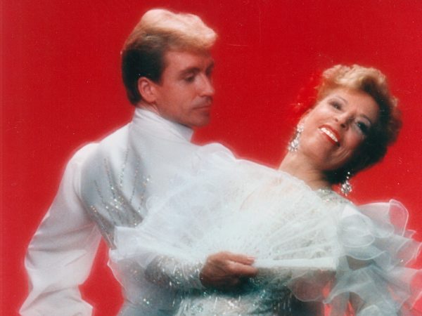 Man and Woman dancing together in fancy sparkly outfits