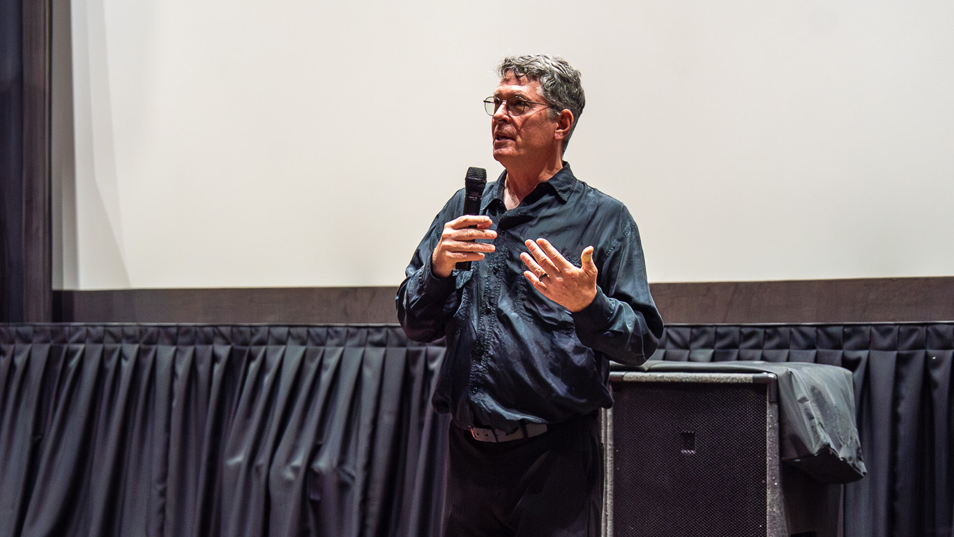 man with microphone speaking/presenting