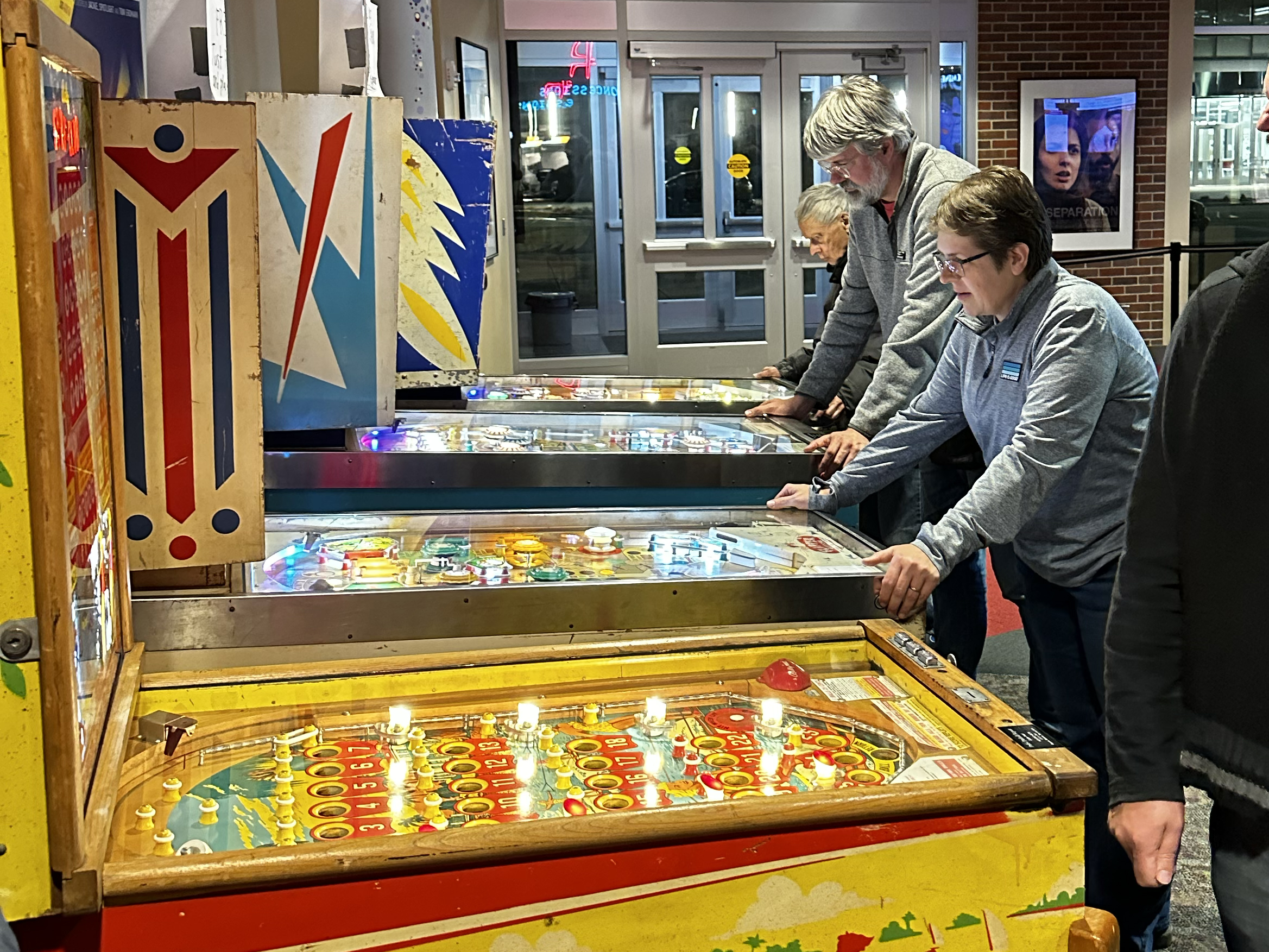 People playing pinball