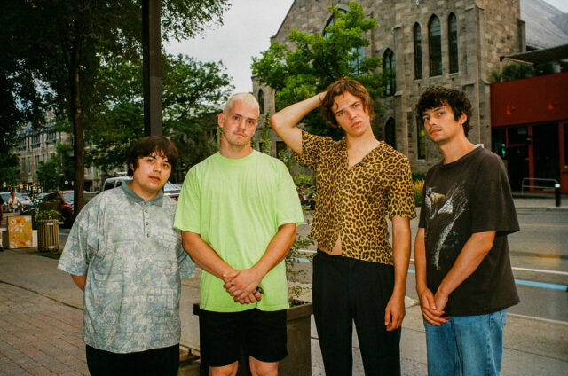 A scene from Mile End Kicks. Four indie band members in 2011 pose for a publicity photo on a city street.