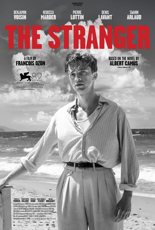 Movie poster for The Stranger. Red text over a black and white photo of a man standing on a beach.