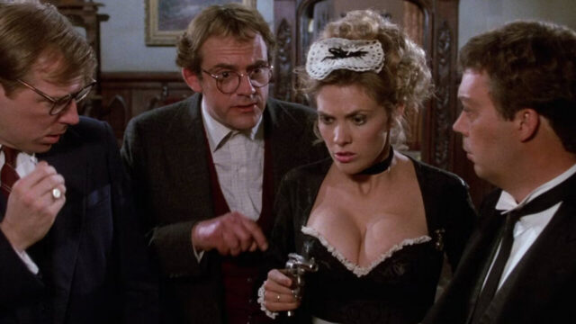 Michael McKean, Christopher Lloyd, Colleen Camp, and Tim Curry in a scene from Clue.
