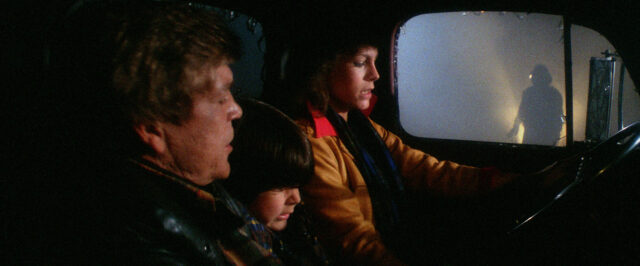 Tom Atkins, Ty Mitchell, and Jamie Lee Curtis in a scene from The Fog.