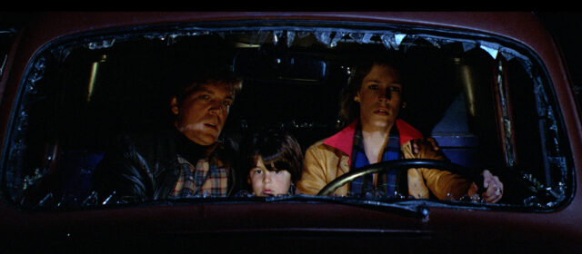 Tom Atkins, Ty Mitchell, and Jamie Lee Curtis in a scene from The Fog.