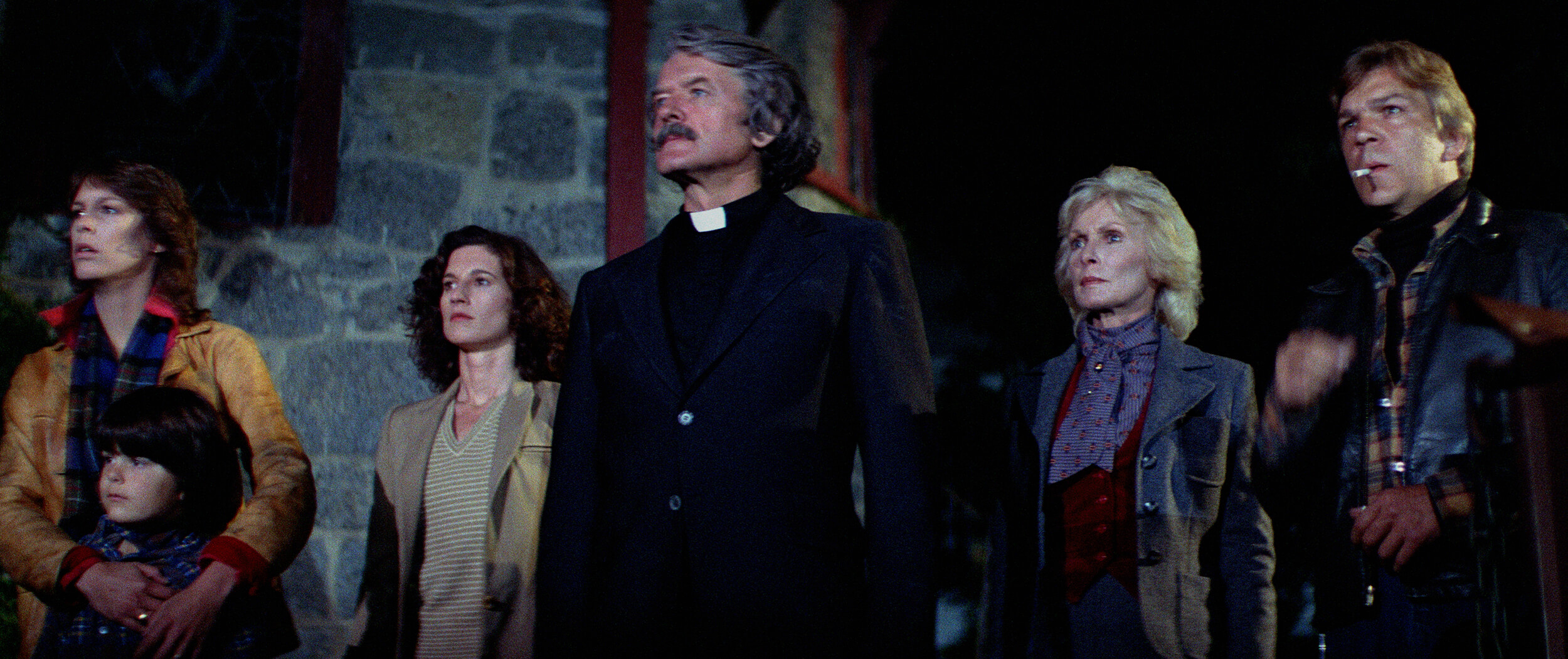 Jamie Lee Curtis, Ty Mitchell, Nandy Kyes, Hal Holbrook, Janet Leigh, and Tom Atkins in a scene from The Fog.