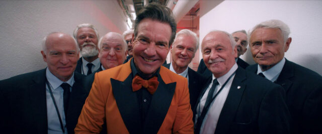 Dennis Quaid and cast in a scene from The Substance.