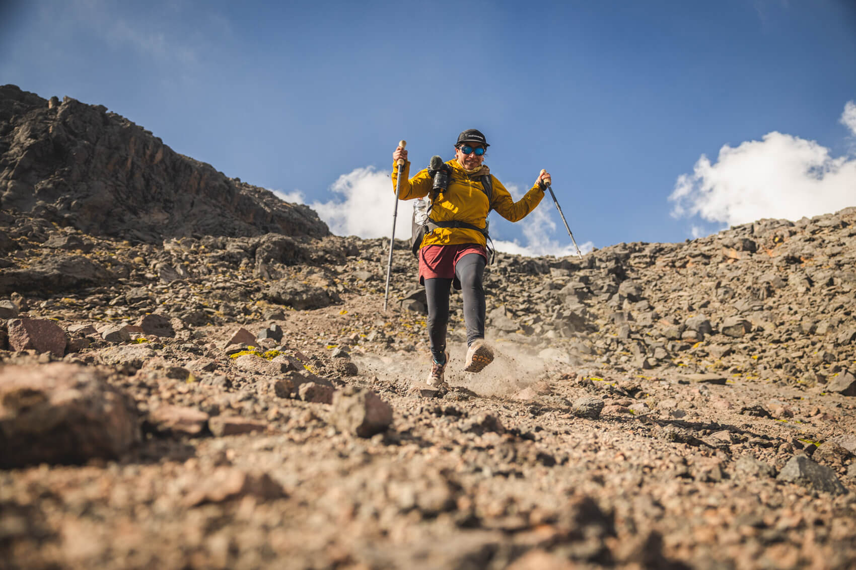 A person hikes down a mountain in a scene from Zelzi Footprints that Inspire.